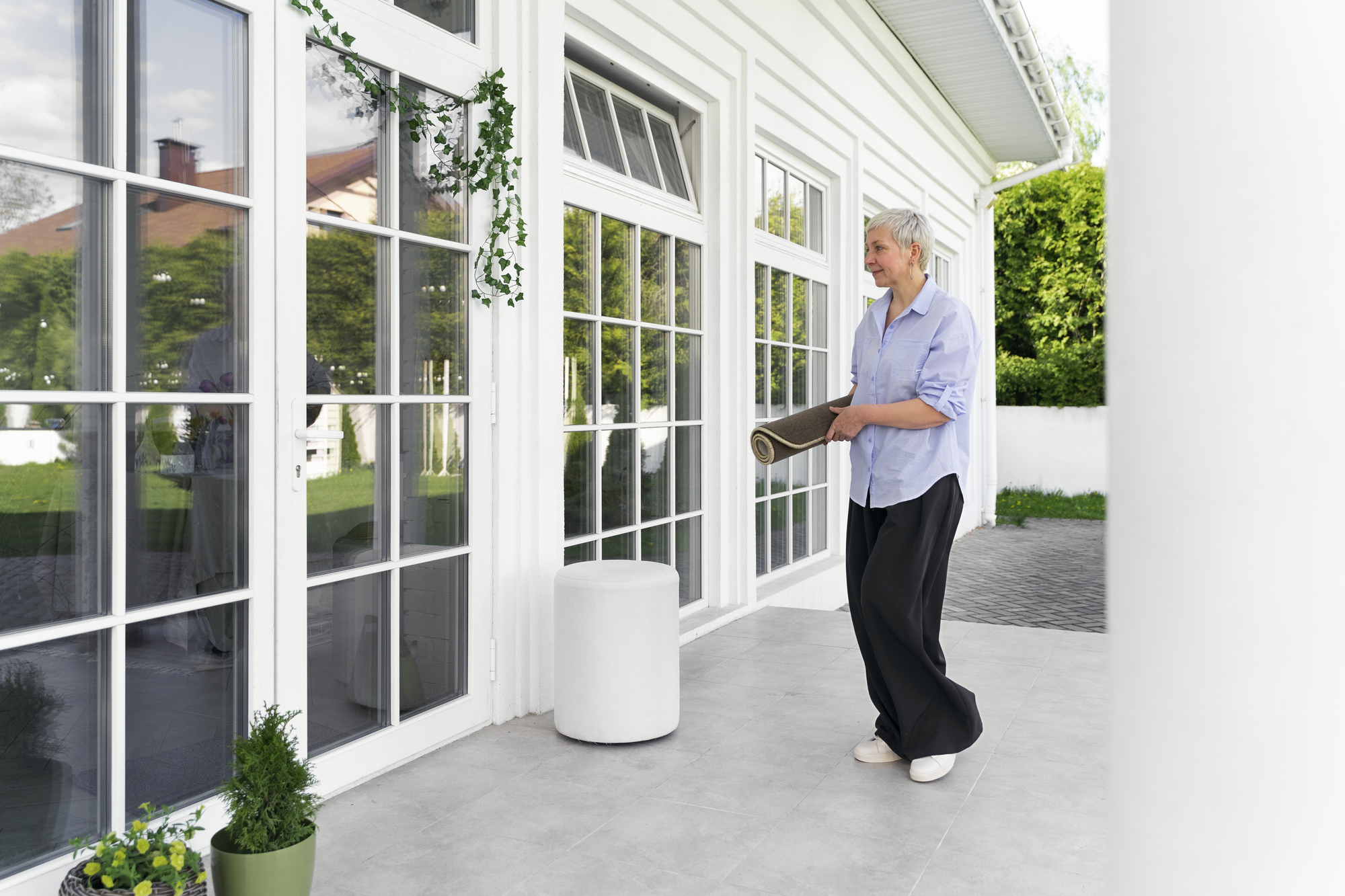 full-shot-woman-decorating-front-door-outside.jpg