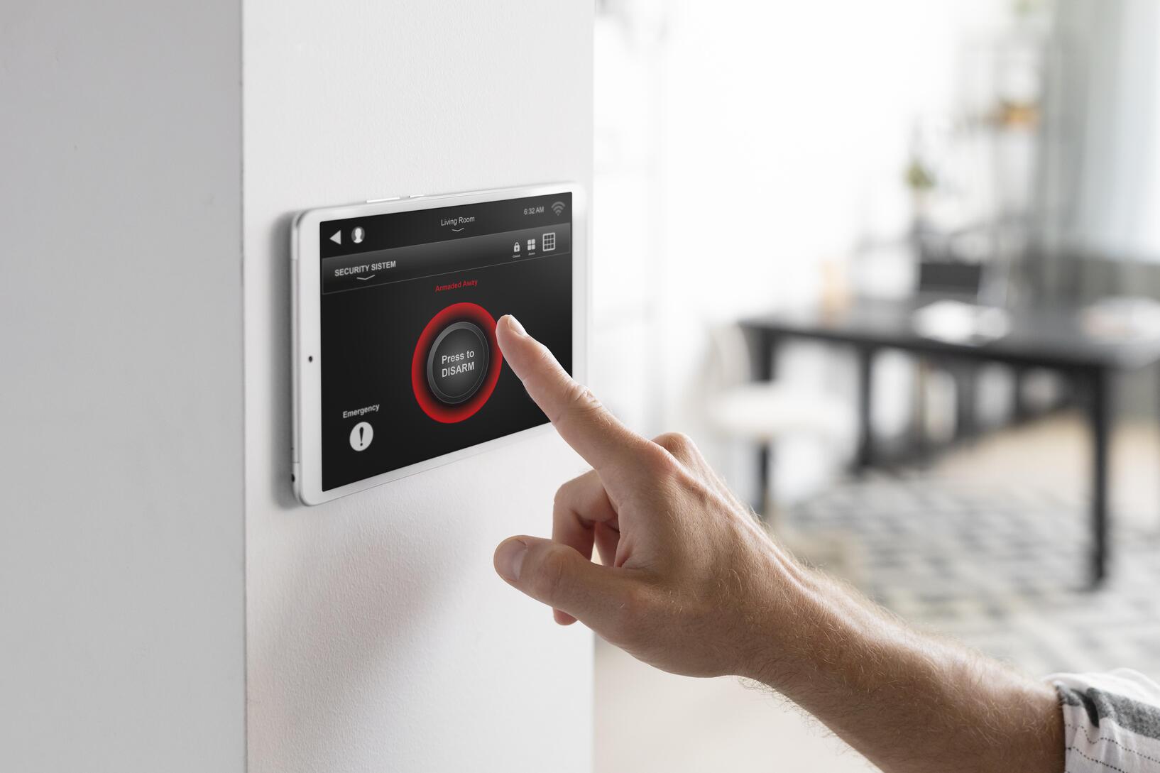 Alarm Systems Comparison 5 man-using-tablet-his-smart-home.jpg