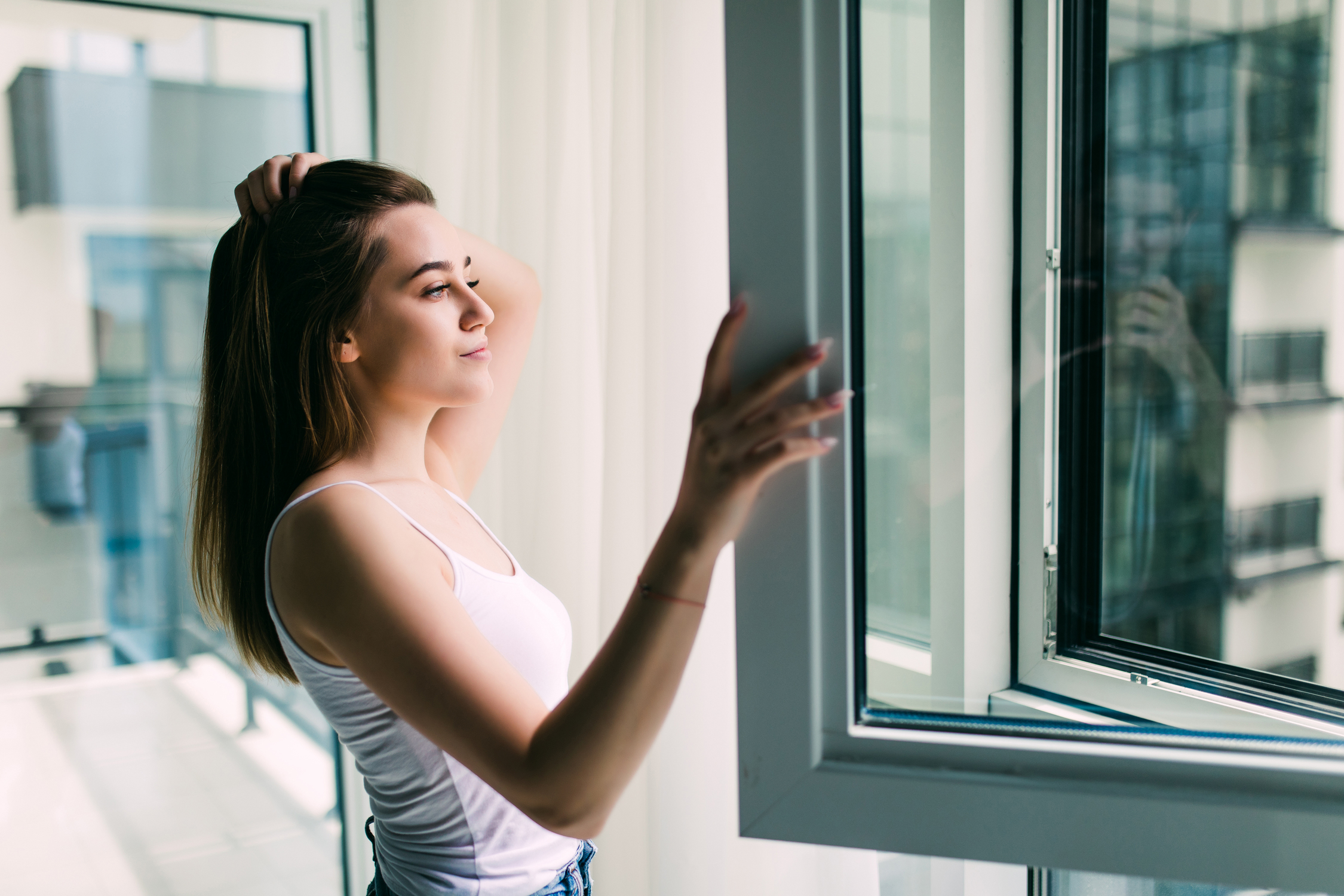 young-woman-opens-plastic-window-fresh-air-smiling-home.jpg